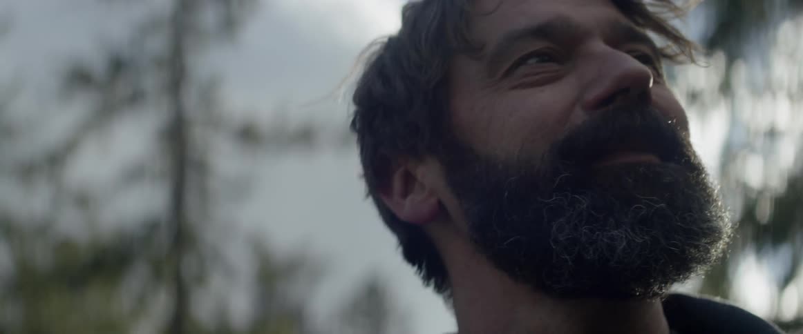A man looks around and smiles