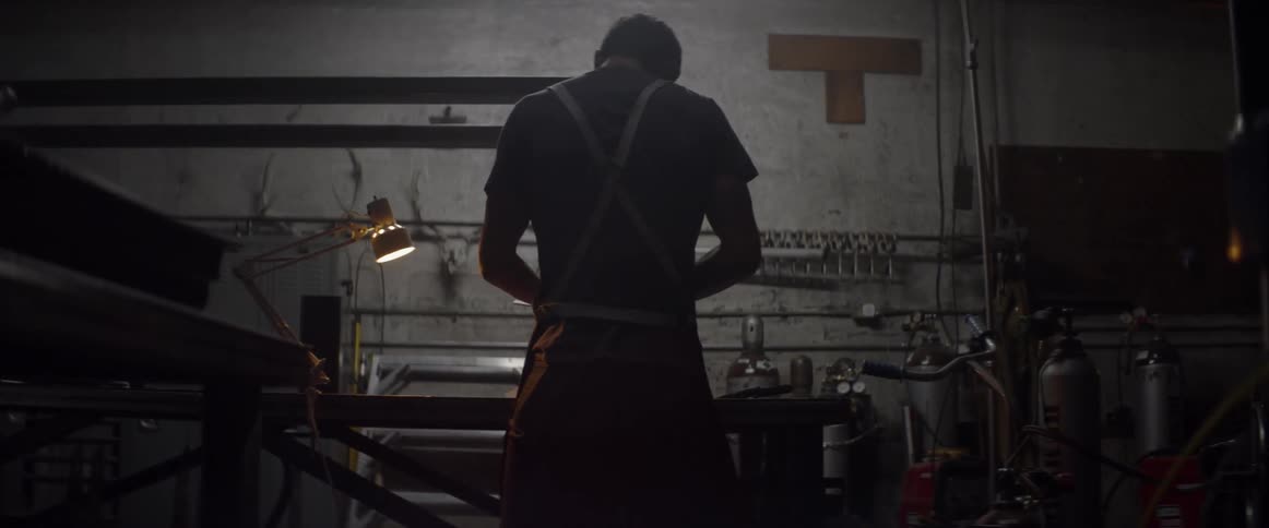 A man is working in his dark shop