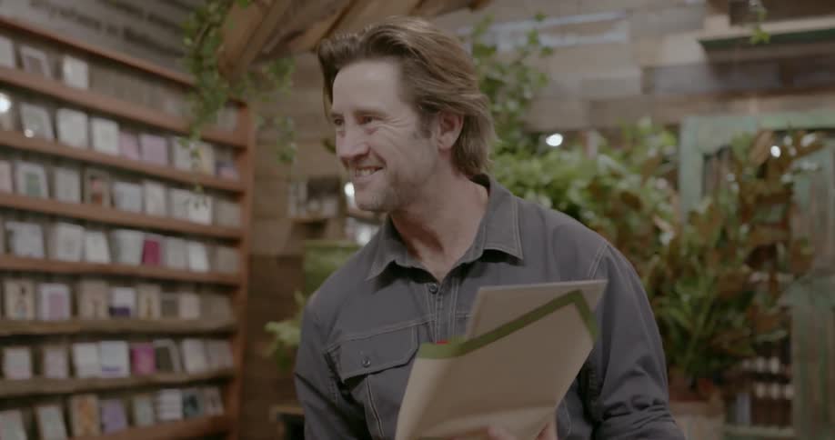 A man picks up his flowers from the shop