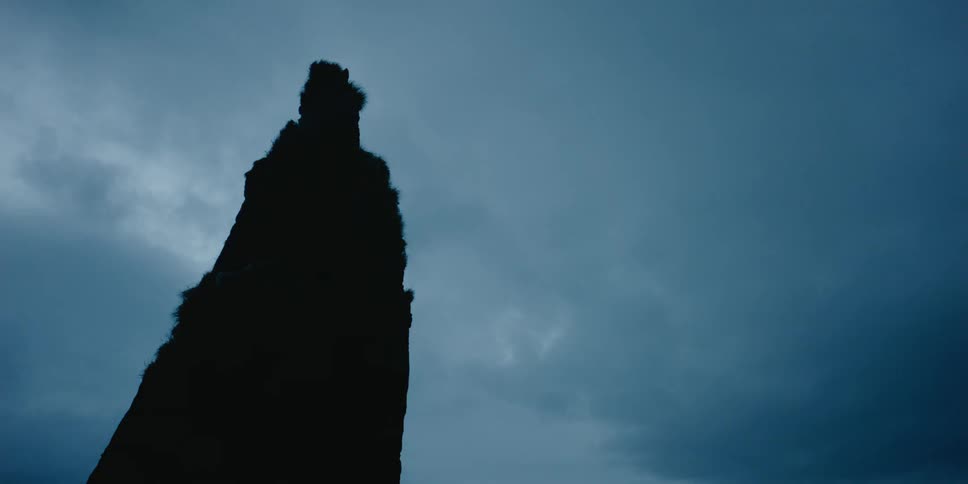 Clouds are drifting over a rock pillar on a cloudy day