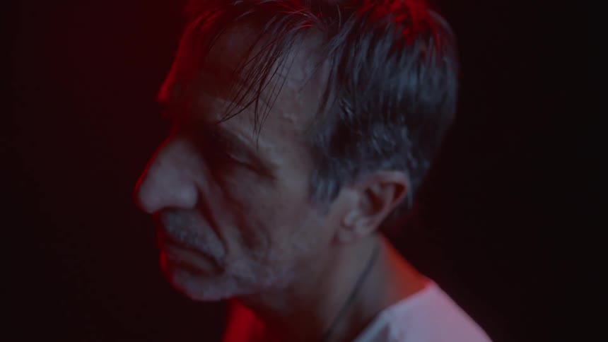 A man is standing in the dark room