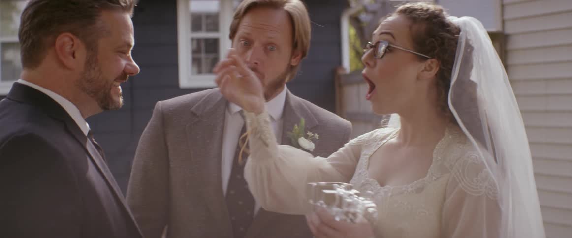 A newly married couple exchange a gift