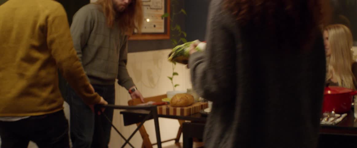 People bring food over to the dinner table