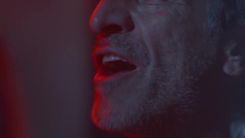 A man is yelling towards someone