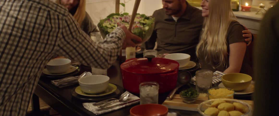A group of people set the table for dinner