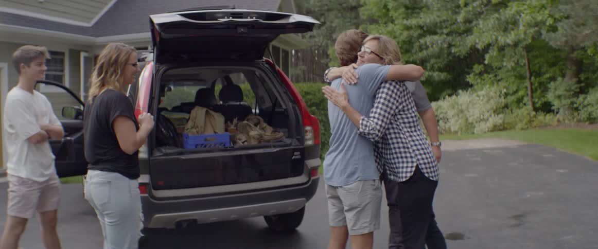 A family gathers around as a child packs up to move out