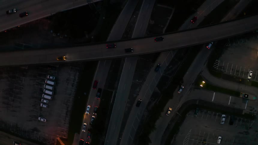Vehicles travel on highway roads at night