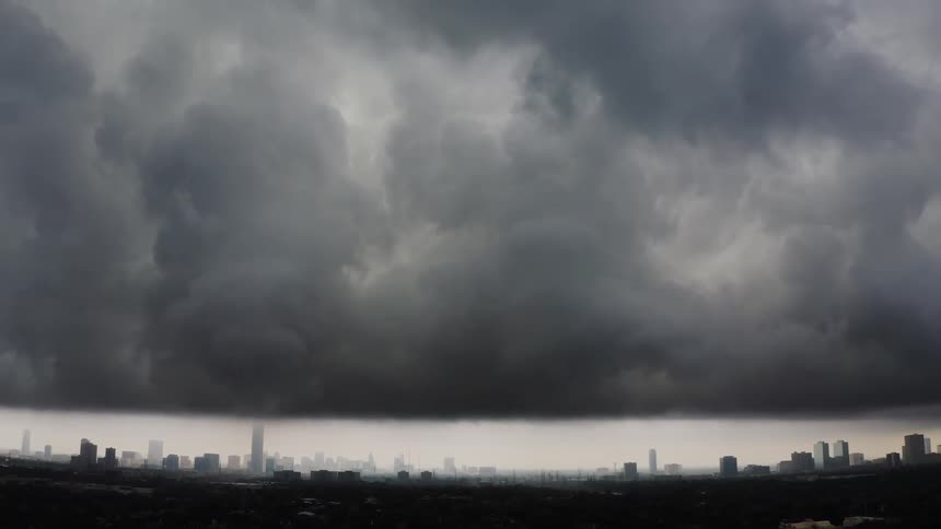 Clouds roll toward a city