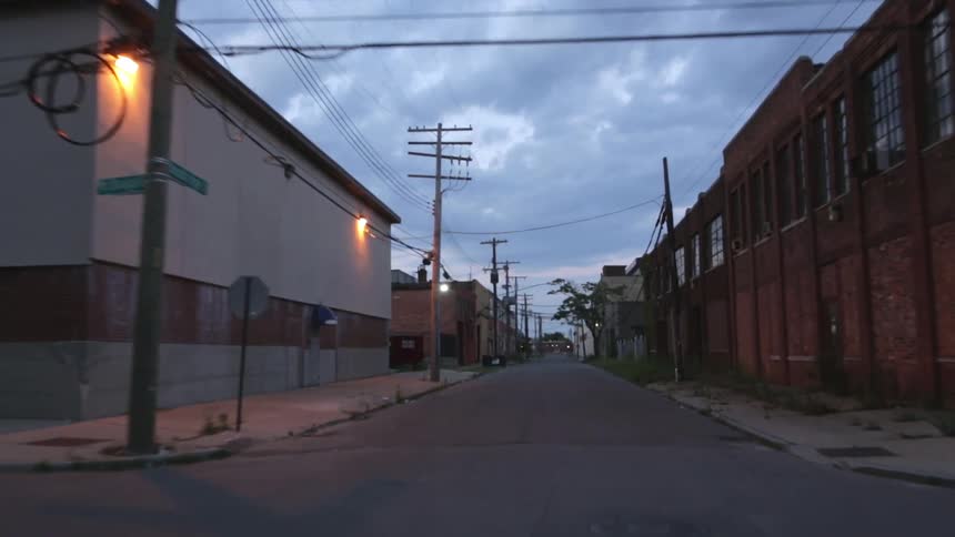 A vehicle travels down a town road