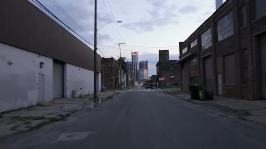 A street in a metropolis lined by ruined and abandoned buildings