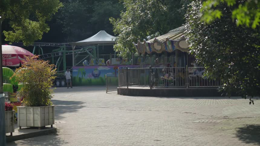 A carousel spins in an amusement park
