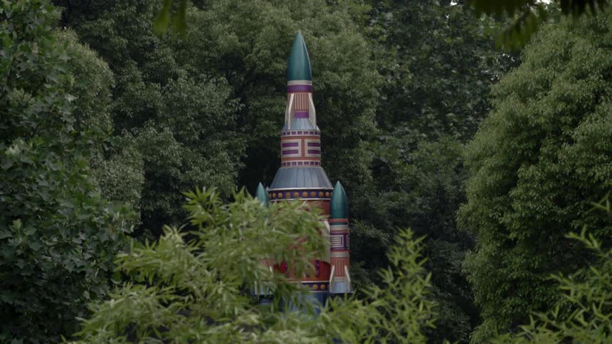 A spinning castle top is sticking above the treeline