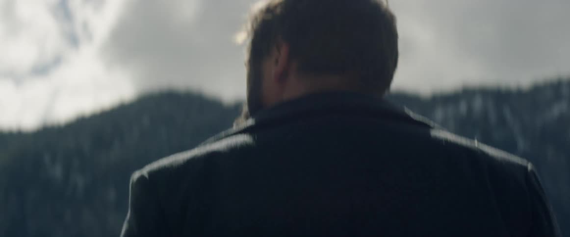 A man walks out under the sun in nature