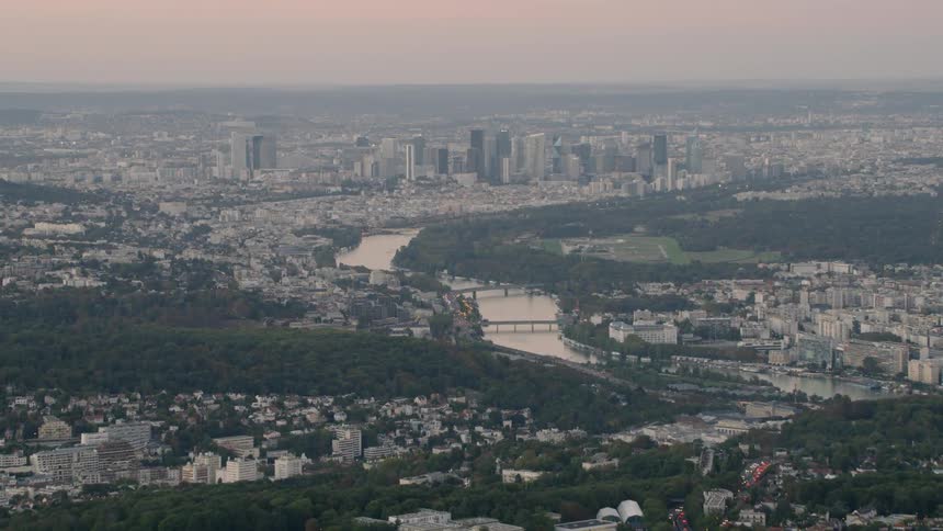 A river winds through a large city at sunset