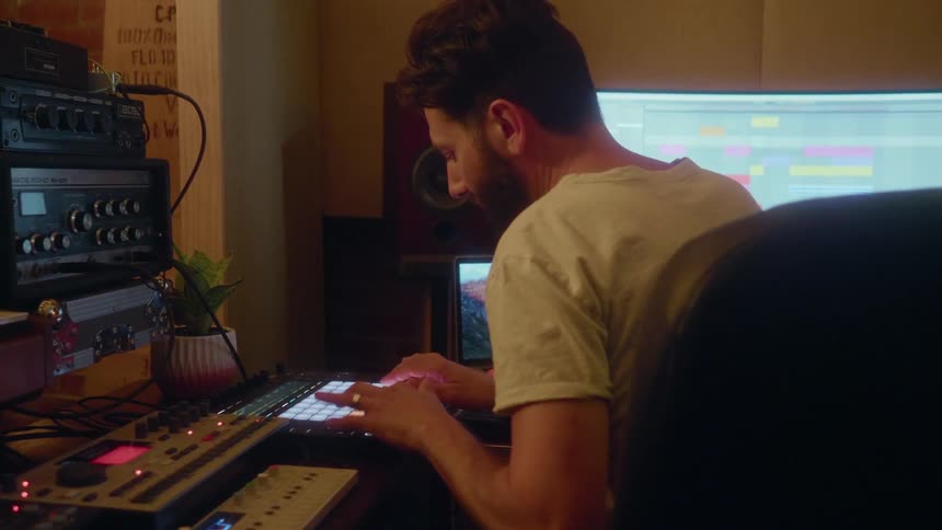 A musician records with a midi controller instrument