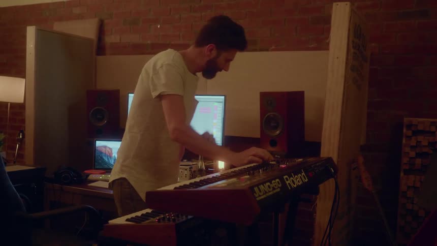 A man is mixing music in a studio