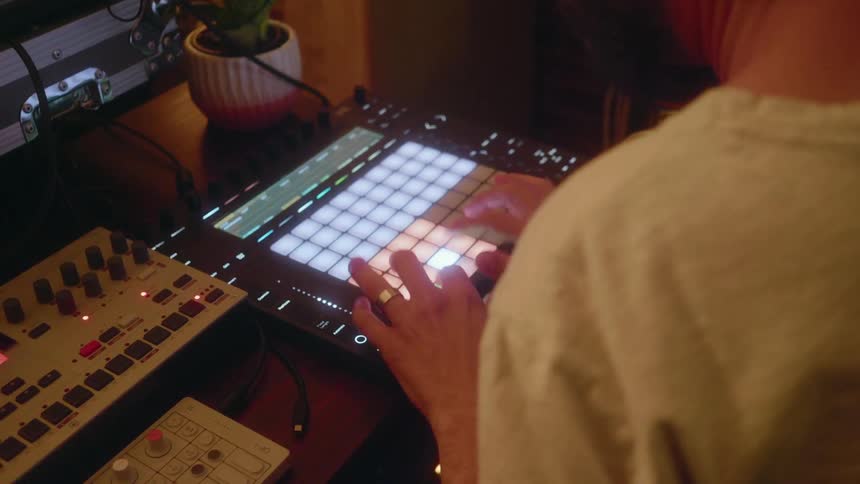 Man types on a board with many colored lights