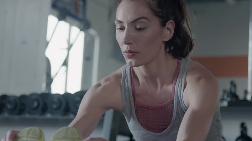 Woman stretches in a gym