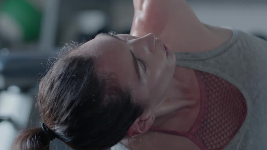 Woman exercising using a barbell in a gym
