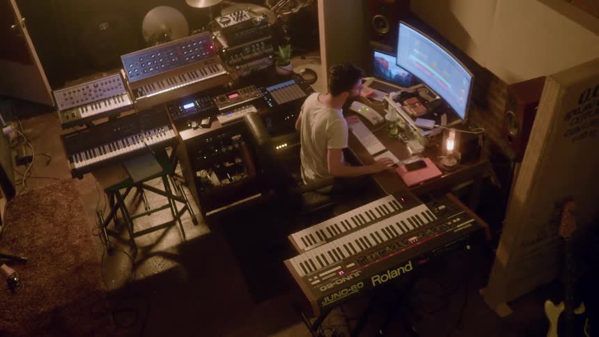 A man is working in a music studio