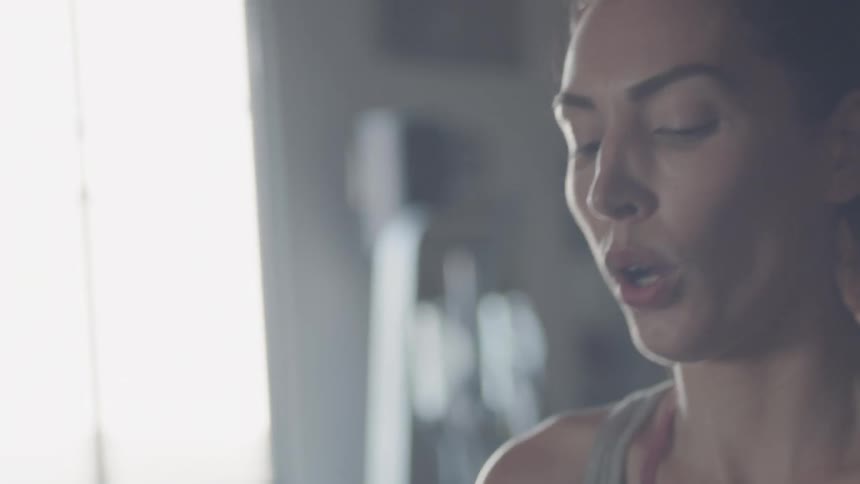 Woman breathes heavily after a workout