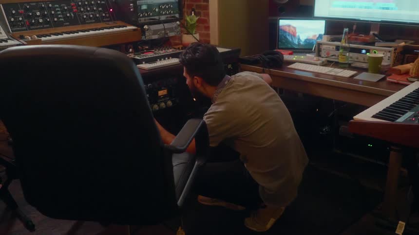 Man adjusting equipment in a recording studio