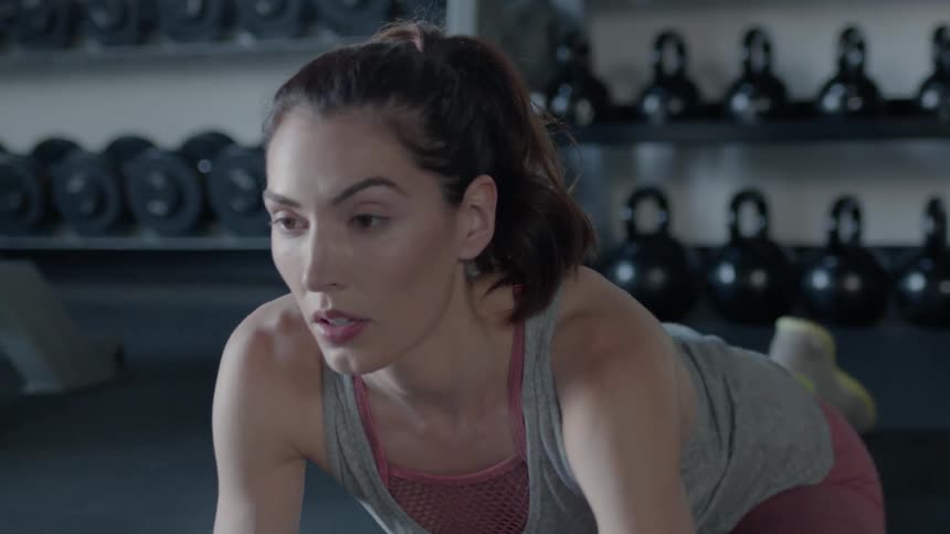 Woman stretches in a gym