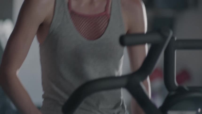 Woman rides on an exercise bike