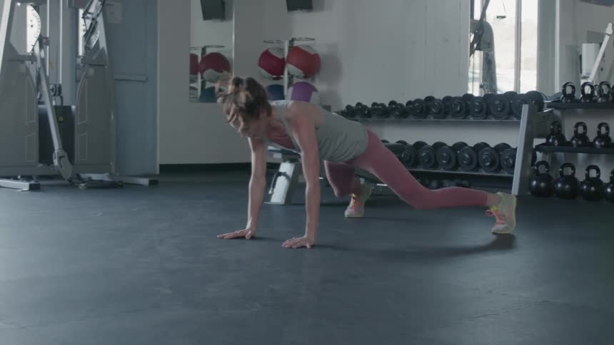 A woman stretches in a gym