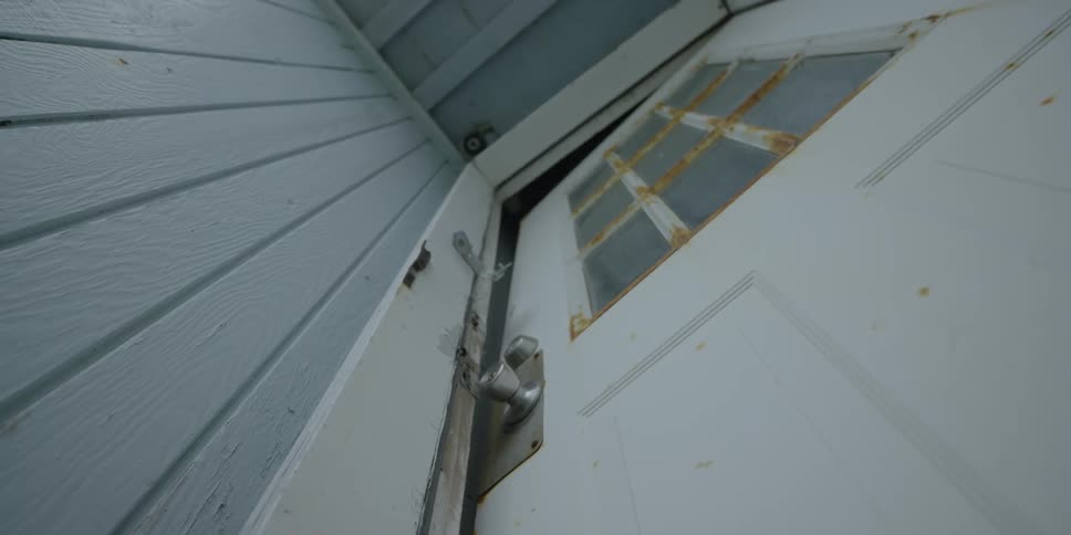 A rusty door is a little bit open