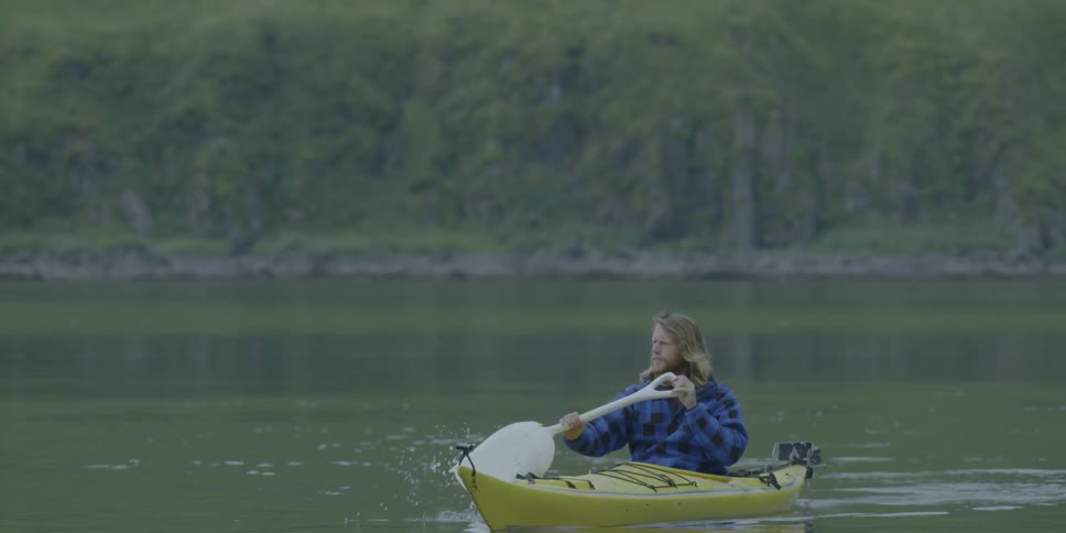 Man kayaks on the water