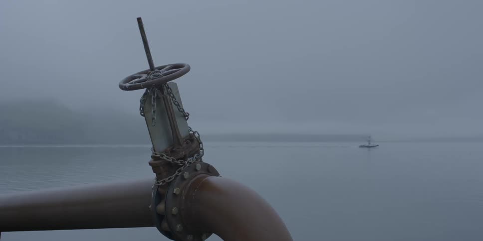 A boat moves across calm waters