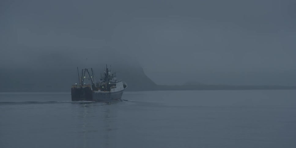 A ship moves across calm seas