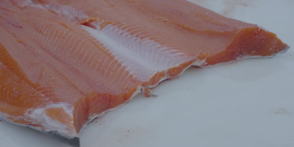 A salmon fish fillet rests on a table