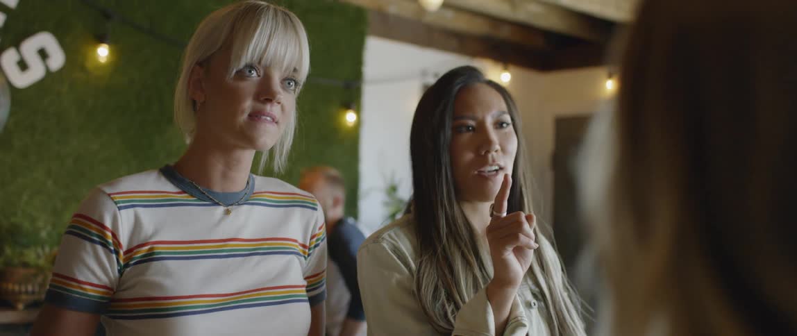 Two women talk while ordering in a coffee shop
