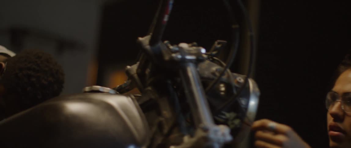 A man works on a motorcycle in a garage
