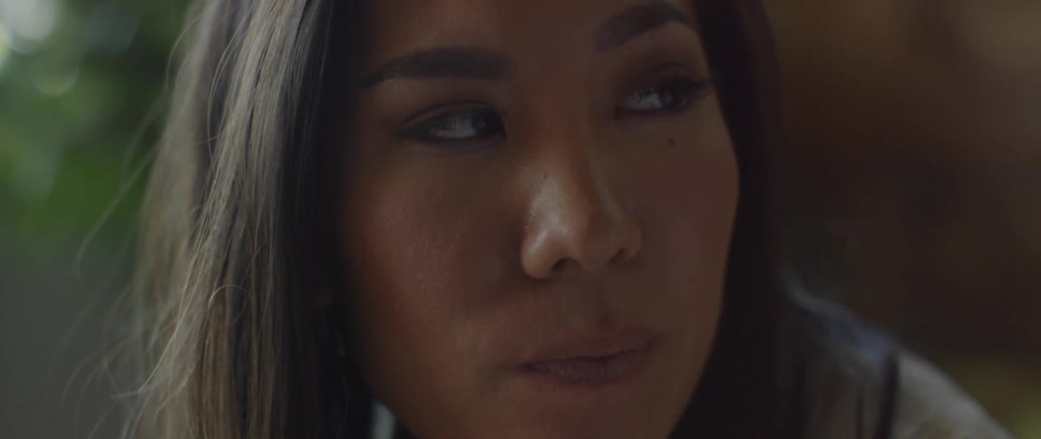 A sad looking woman glances to her side