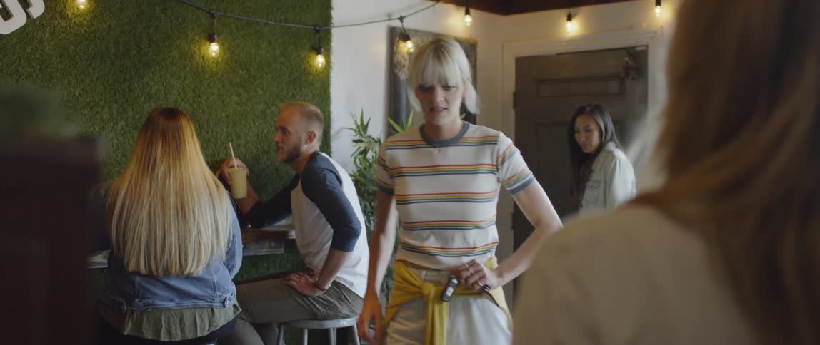 Two women enter a smoothie restaurant