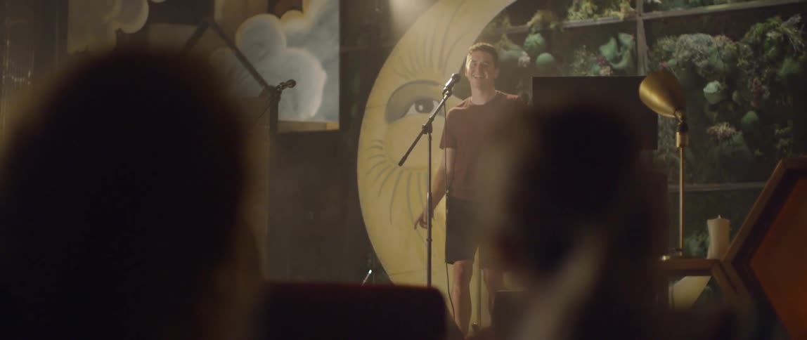 A man dances and performs at a karaoke bar