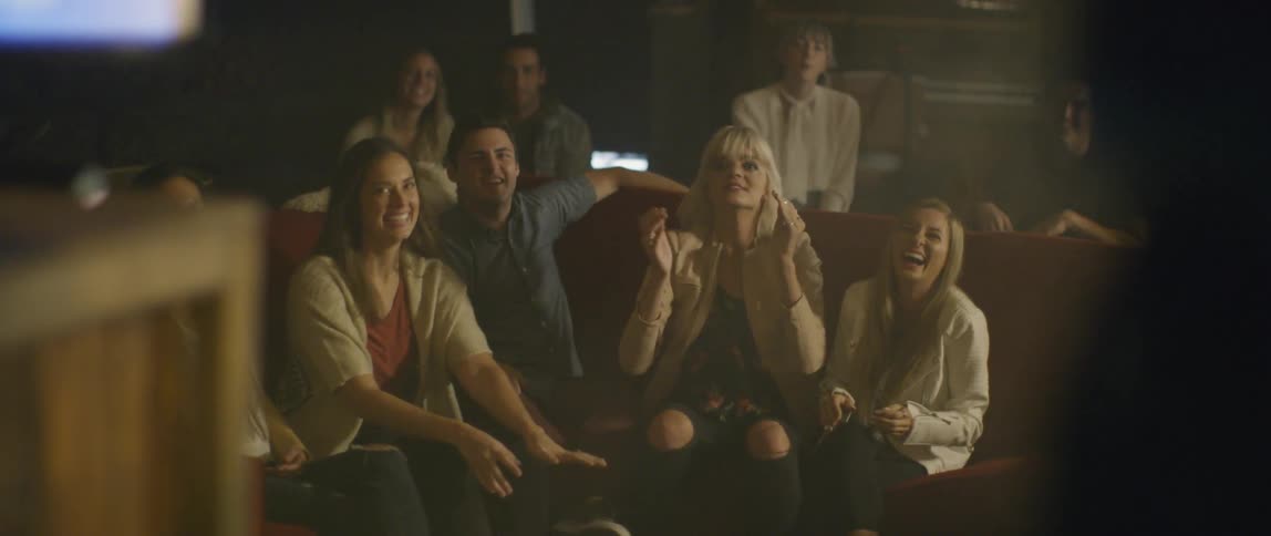 A group of people dance at a karaoke bar