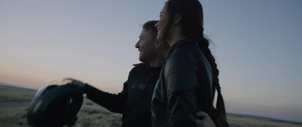 A man and woman hug on the beach