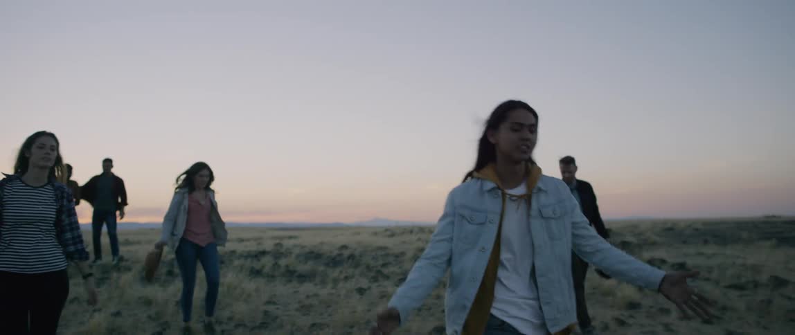 A group of people walk out in nature