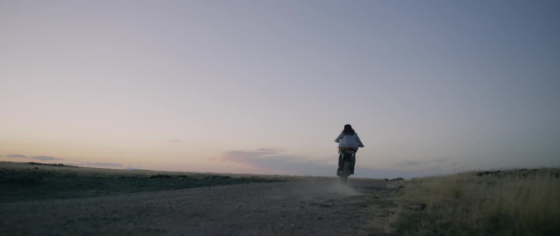 A man rides off on a dirt bike
