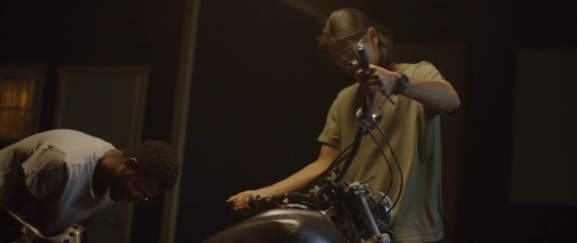 Two men working on a motorcycle