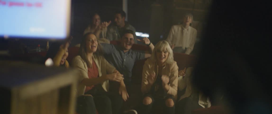 People dance and celebrate at a karaoke bar