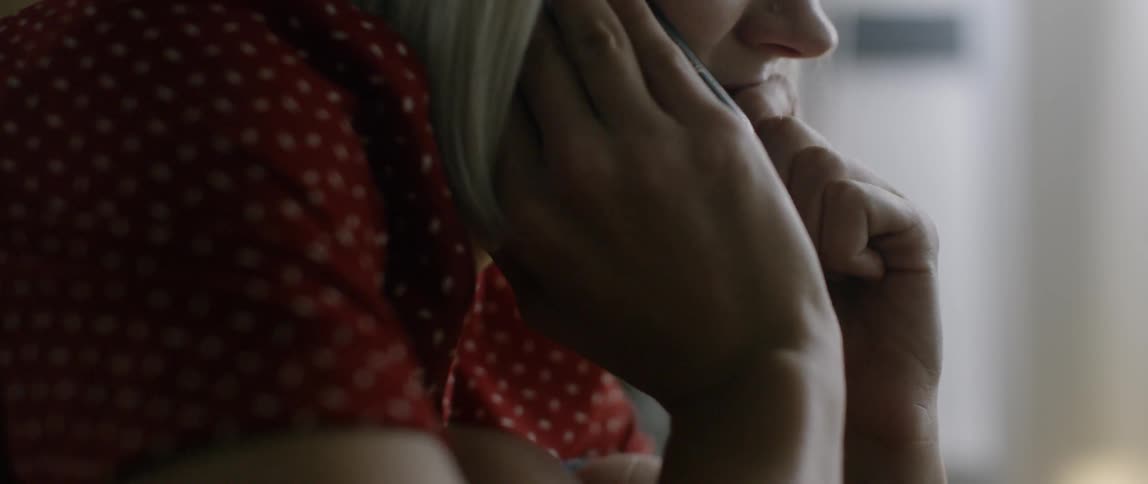 Woman talks on phone and nods head