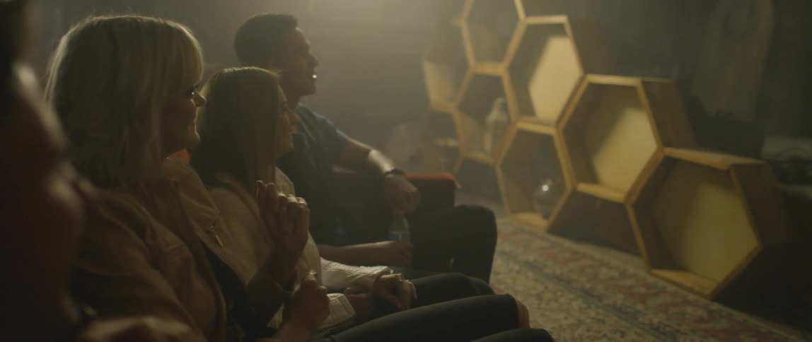 A group of people dance on a couch at a karaoke bar