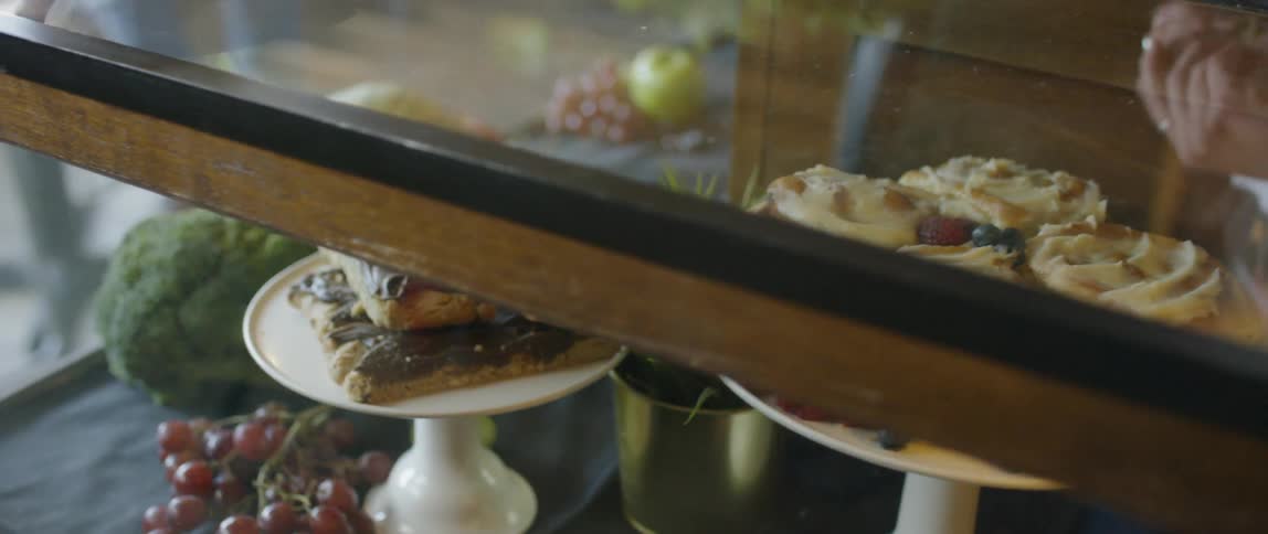 Pastries and fruit are displayed in a case