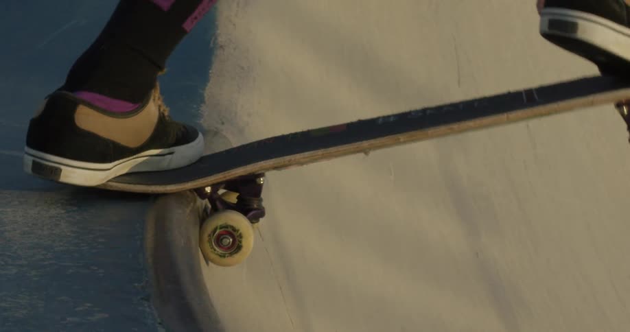 A skateboarder descends into a skatepark