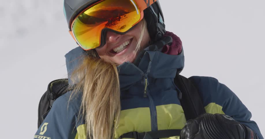 A woman smiles with ski gear on